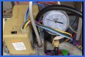 How do you test a Honeywell gas valve with a multimeter?